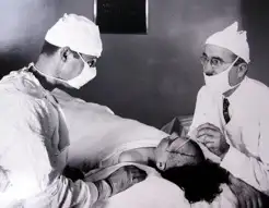 Freeman operating on a patient with his partner, James Watts